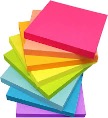 An image of a stack of sticky notes, assorted colours